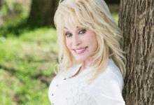 Dolly Parton Reassures Fans with a bright smile while posing outdoors, confirming her wellbeing after recent health rumors.