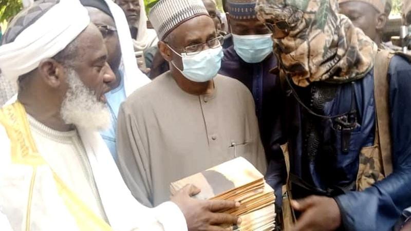 Sheikh Ahmad Gumi negotiating with a member of Bandit terrorist, Handling them Islamic books to repent. Photo credit: BBC